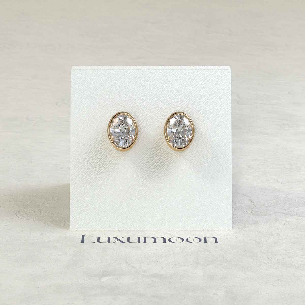 The Orel – 2 Ct Oval Diamond Solitaire Studs in Sleek Full Bezel Setting