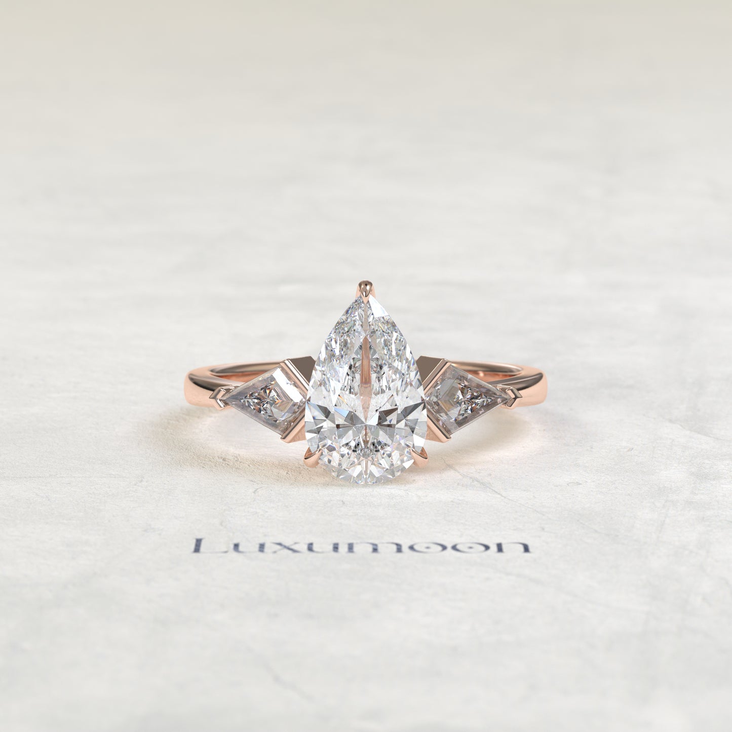 The Loela – Pear Cut Lab Grown Diamond Kite Side Stone Three Stone Engagement Ring