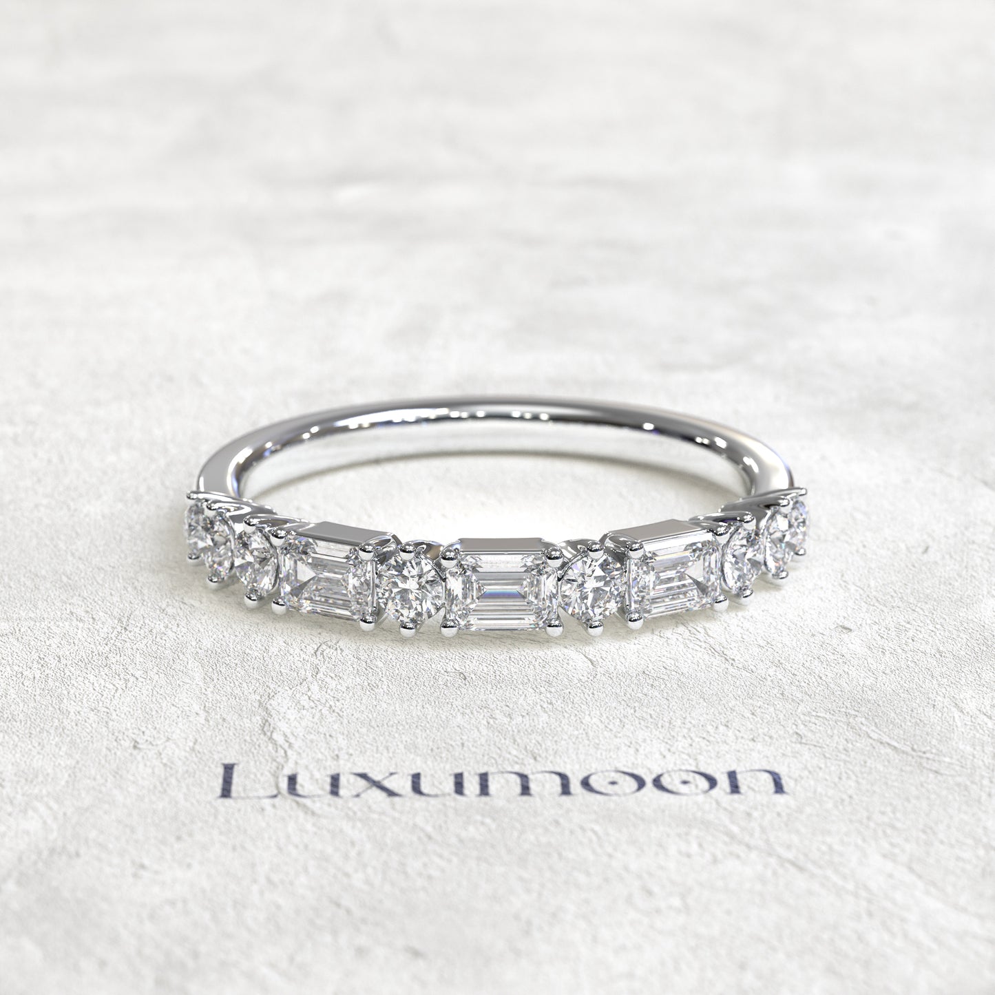 The Solenthia – East-West Emerald & Round Diamond Band